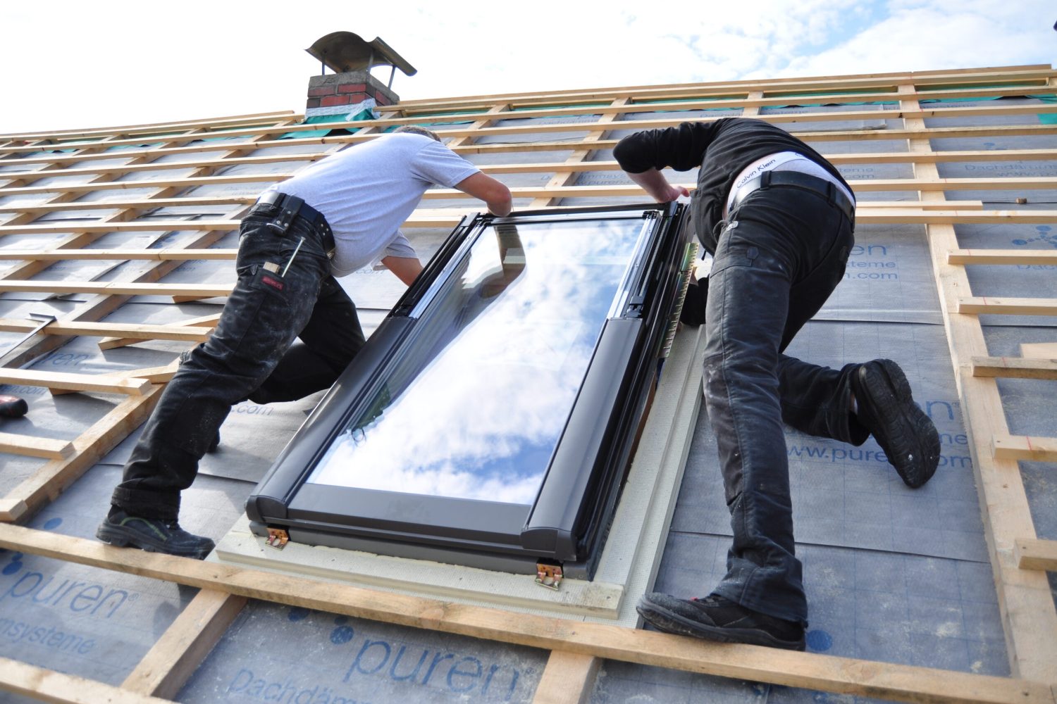 two-men-assembling-a-roof-skylight-window-2023-11-27-05-23-24-utc (1)